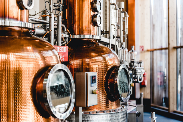 alembic still for making alcohol inside distillery, destilling spirits