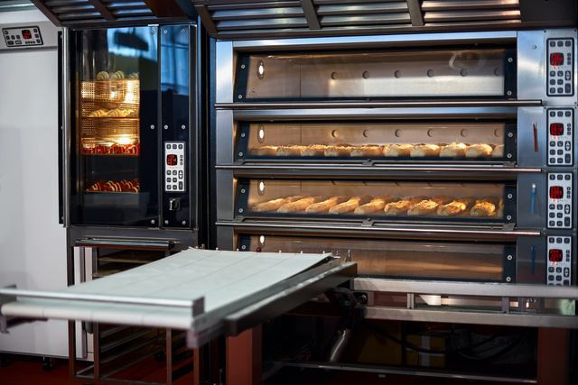 Industrial convection oven with cooked bakery products for catering. Professional kitchen equipment, Professional industrial equipment.