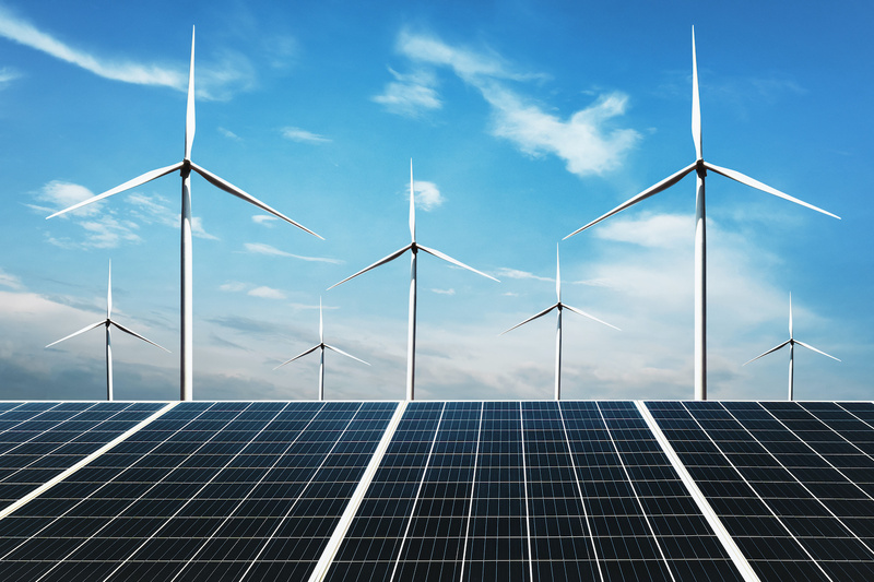 electricity power in nature. clean energy concept. solar panel with wind turbine and blue sky background